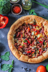 Photo of pizza on the table with ingredients around. Tasty pizza on the wooden background. Flat lay with top view. Italian pizza. Delicious pizza. Image