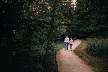 middle age couple walking in the park in summer