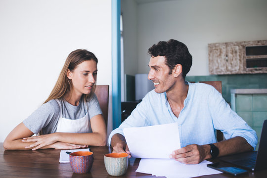 Man and woman reading paper document