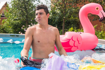 Ecology, plastic trash, environmental emergency and water pollution - shocked man standing in a...