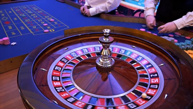 Roulette wheel running in a casino, Poker Chips.Classic casino roulette wheel