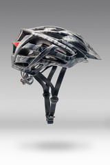 Studio Shot of Gray Camouflage Color Cycling Helmet. Side View of Protective Sports Equipment