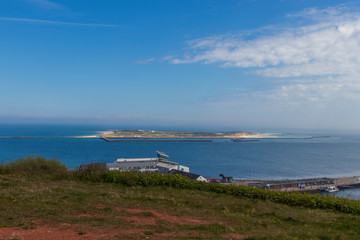 Houses and alleys on the island of Helgoland with a view of the landscape and the background of the island of Dune
