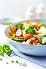 Healthy Salad with Cherry Tomatoes. Cucumber and Sweet Corn. Tasty vegetarian snack. Close up. 