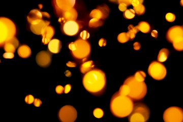 Black background with bright warm bokeh lights. Holiday, Christmas and New Year background. Ideal to layer with any design. Horizontal