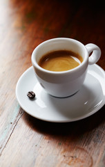 Cup of coffee on brown background. Close up.