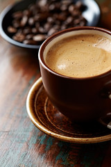 Cup of coffee on brown background. Close up.