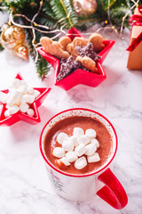 Hot chocolate with marshmallow and cookies in Xmas setting background. Concept of Christmas holiday. Warm tone. Vertical