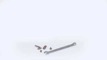 Small wrench and several screws isolated on white background. Repairs concept.