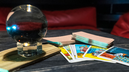 Tarot cards and magic ball on wooden background. Mystical and divination concept.