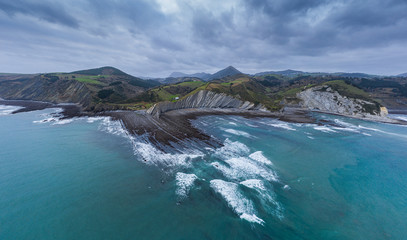 Zumaia and Deba flysch geological strata layers drone aerial view, Basque Country