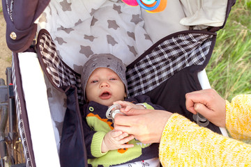 a small child in a stroller on a walk with mom and dad with parents