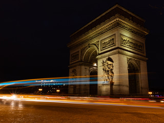 View of famous Arc de Triomphe in Charles de Gaulle square at night in Paris, France