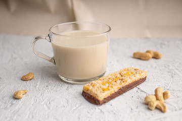 Healthy breakfast. Organic milk. Cereal granola bar. Glass cup with organic milk. Nut milk without lactose, gmo, antibiotics and casein. Diet food.  ..