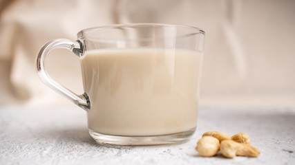 Glass cup with organic milk. Nut milk without lactose, gmo, antibiotics and casein. Diet drink. ..