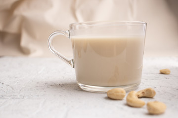 Glass cup with organic milk. Nut milk without lactose, gmo, antibiotics and casein. Diet drink. ..