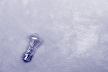incandescent light bulb on white background, copy space top view