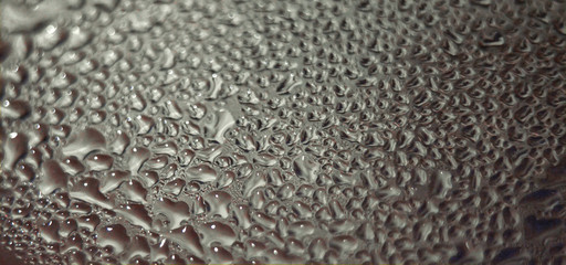 drops of steam on glass blurred background