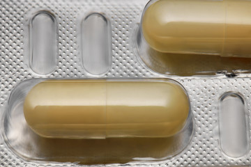 Brown capsules pill in blister pack arranged with beautiful pattern. Global healthcare concept. Antibiotics drug resistance. Antimicrobial capsule pills. Pharmaceutical industry. Pharmacy.