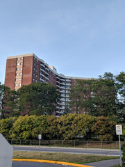Obraz na płótnie Canvas Large apartment buildings in Ottawa Ontario hidden behind greenery.