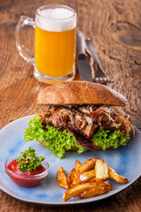 pulled pork in a bun with beer