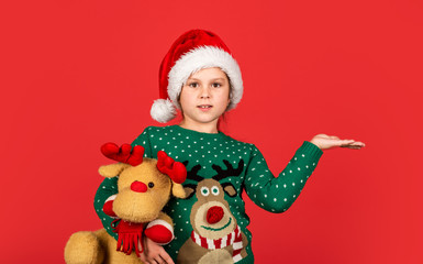 Try it. xmas party surprise. winter holiday mood. surprise for new year holiday. everyone will get a present. small girl santa with toy, copy space. kid with purchase. christmas shopping and sale