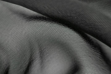 The texture of the mesh fabric close-up, macro photo. Spectacular background abstract image.