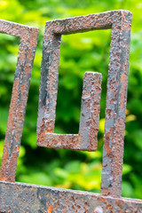 Closeup of rusty fence with spiral patterns