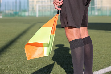 Assistant football referee and referee's flag. Soccer referee.