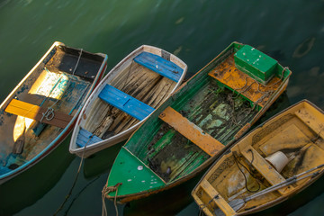 Fototapeta na wymiar Looking downward at four colourful rowboats tied to Fisherman' Wharf Monterey California nobody
