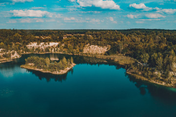 Fototapeta na wymiar Fantastically beautiful landscape of basalt columns and azure lake in Ukraine.