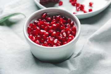 Bowl with pomegranate seeds on table