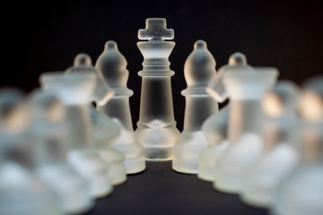 Elite glass chess. Randomly constructed pieces. Close-up on a black background.