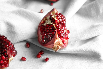 Pieces of tasty pomegranate on napkin