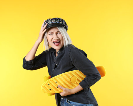 Emotional Mature Woman With Skateboard On Color Background