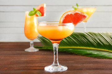 Glass of fresh citrus juice on table