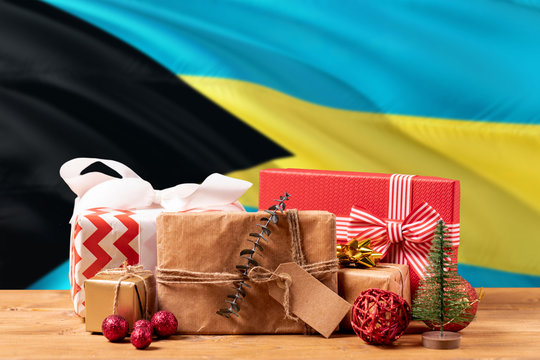Bahamas new year celebration theme. Wrapped christmas gifts on waving national flag background. Merry christmas concept.