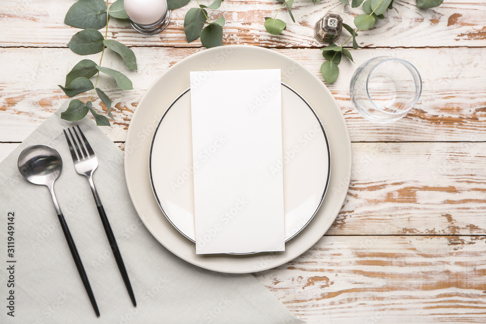 Wall mural beautiful table setting with empty menu on white wooden background