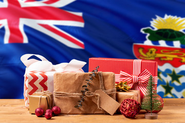 Cayman Islands new year celebration theme. Wrapped christmas gifts on waving national flag background. Merry christmas concept.