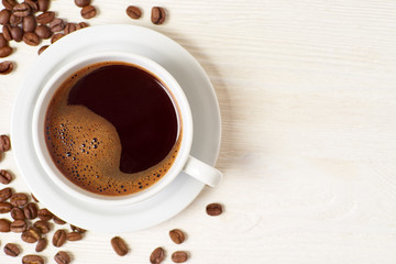 Americano and coffee beans on white wooden table