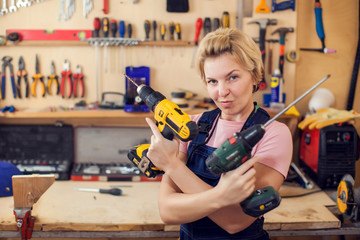 Young handy woman with short blond hair working with screwdriver.