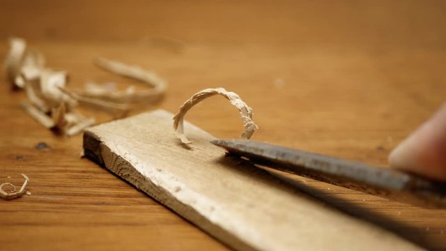 Wood Chisel Cuts Into Cedar Shim Peeling Up Wood Strips