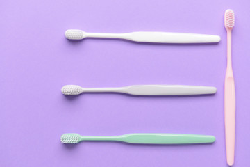 Tooth brushes on color background