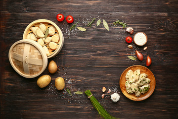 Obraz na płótnie Canvas Composition with tasty dumplings and space for text on wooden background