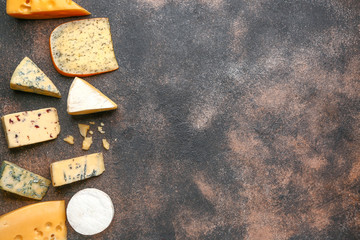 Assortment of fresh cheeses on grey background