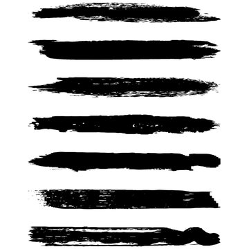 A set of grunge brushes. Dry brush strokes on a white background. Abstract black lines. Ink spots