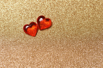 Two red hearts on the gold background, love concept for Valentine's Day