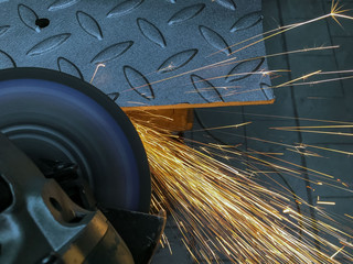 Grinding of sharp edges of metal. Sparks.