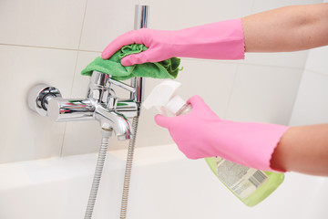 cleaning service. wiping bathroom faucet tap