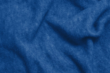 Classic blue colour monochrome texture knitted fabric. Blue knitted Jersey as textile background. Classic blue color background. Wool knitting texture. Trendy color 2020.